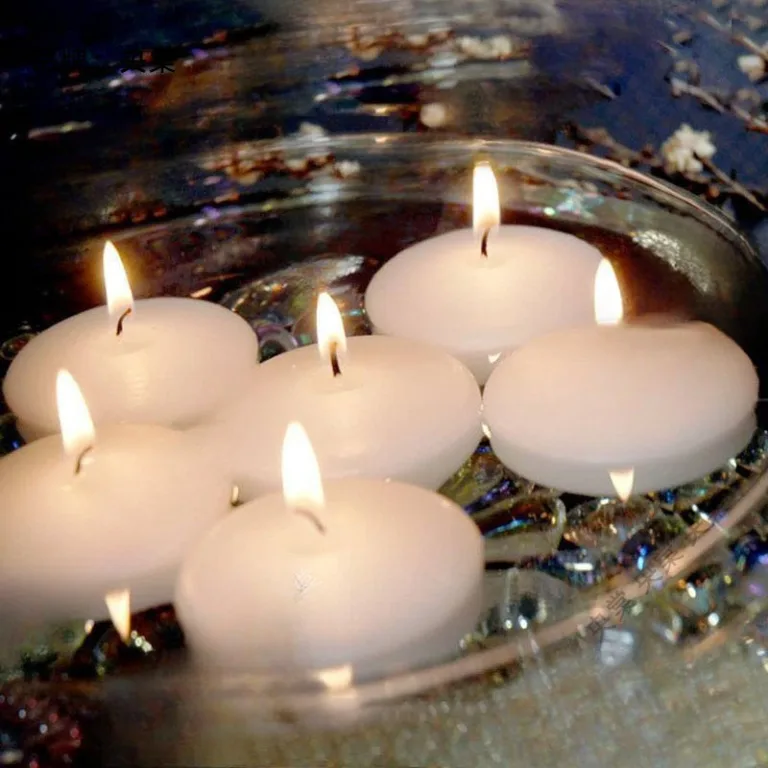 Eco-friendly soy wax floating candles burning on water surface, soft light reflection for event decoration.