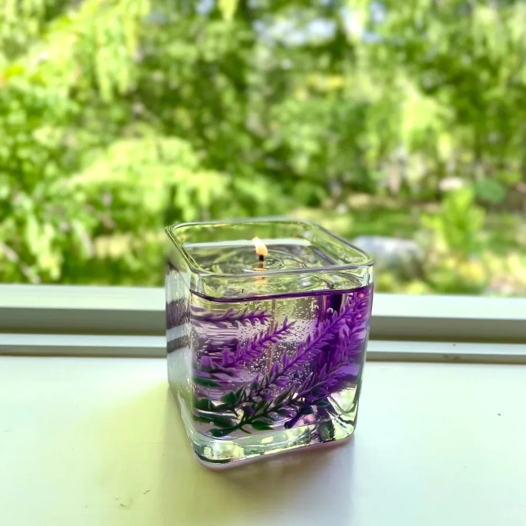 floral-embedded gel candle in clear glass cube