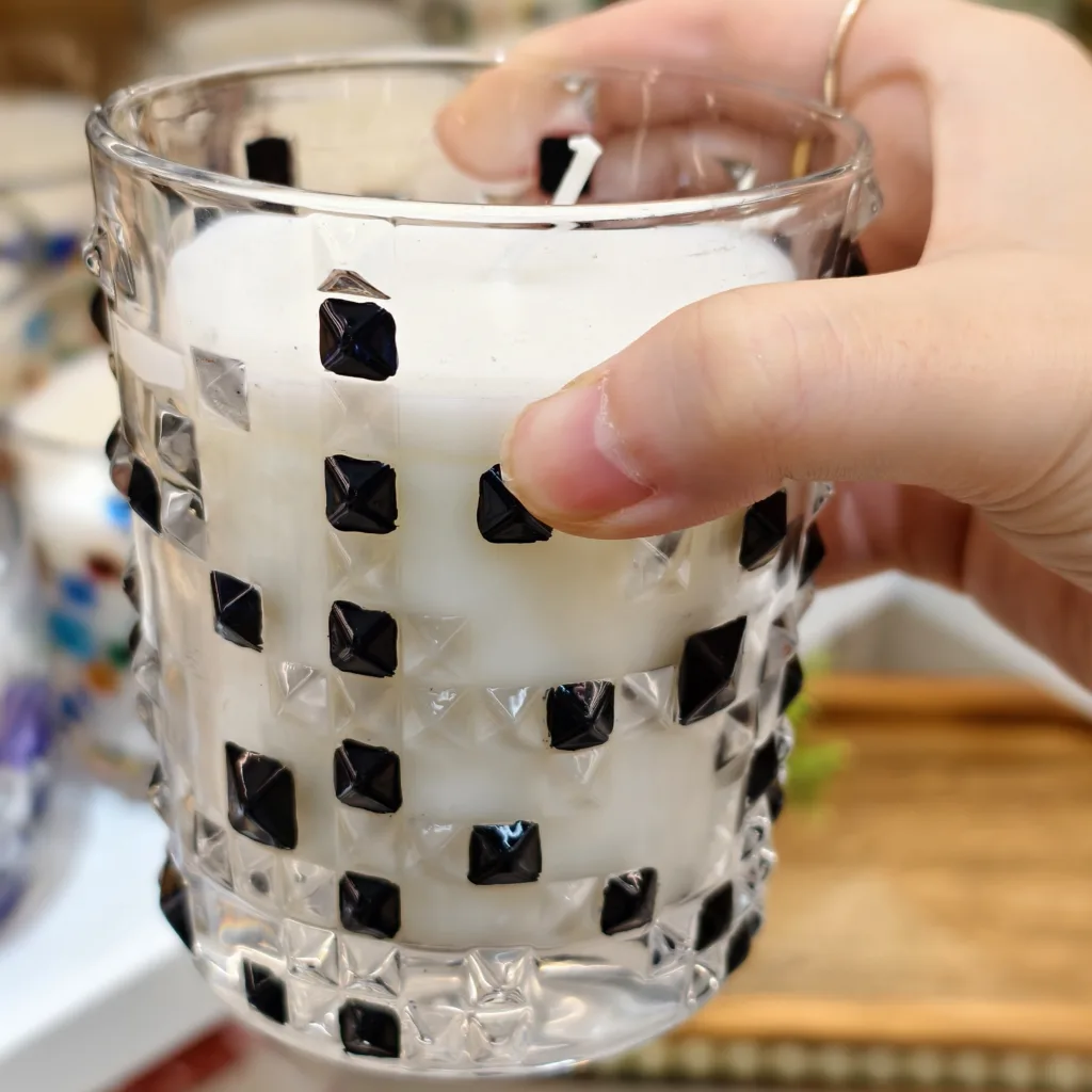 How to Order Custom Printed Painted Glass Candle Jars 4 a textured glass candle jar decorated with raised black square studs around the surface.