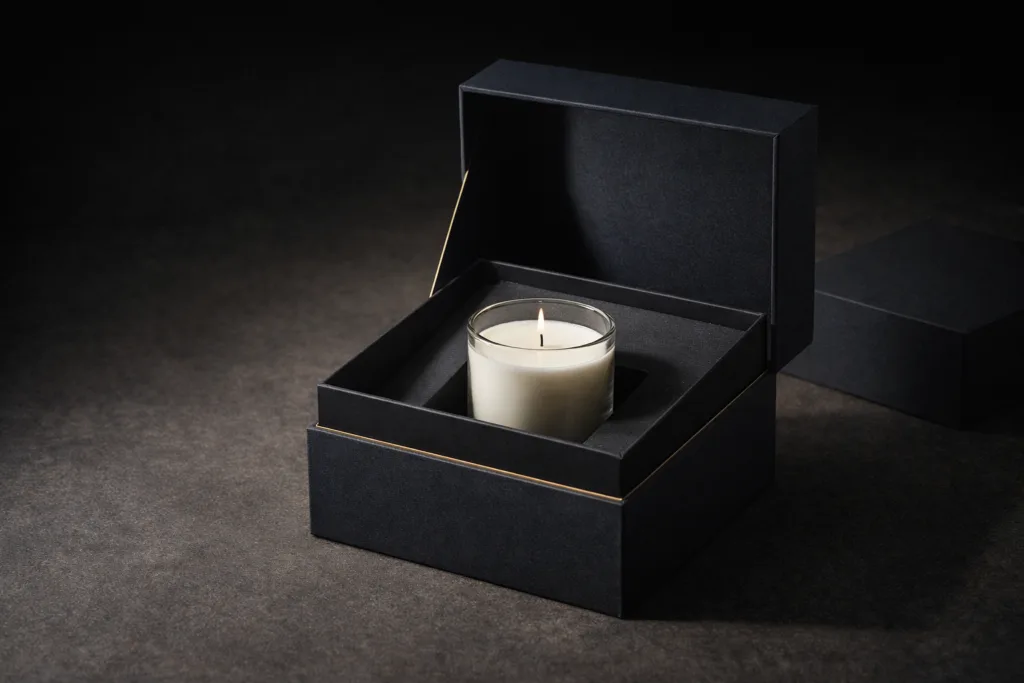 The Luxury Playbook: What Candle Brands Can Learn from Fashion Houses 3 Luxury rigid magnetic box opened to reveal premium candle inside custom insert, deep muted tones, elegant unboxing experience